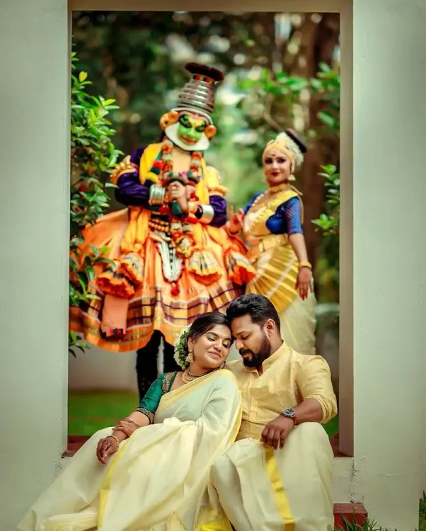 Bride and groom seated with traditional Kerala performers during a wedding celebration