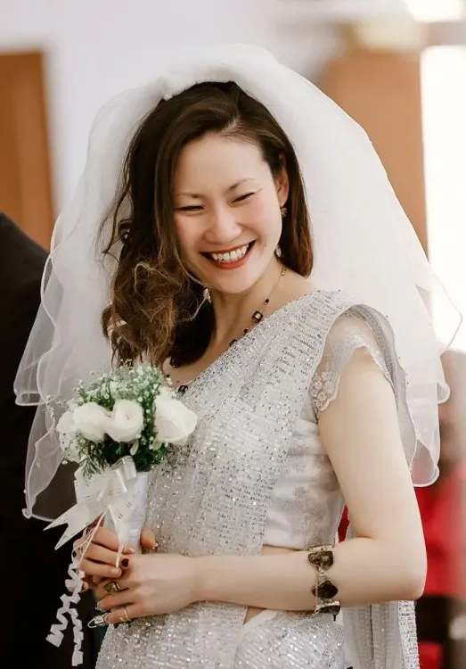 Bride smiling while holding a bouquet on her wedding day