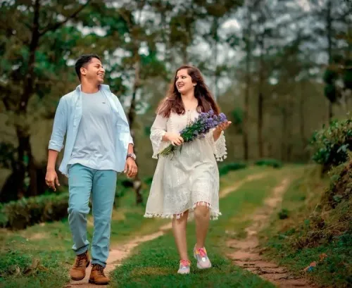 Couple walking together through a wooded setting during a pre-wedding photoshoot